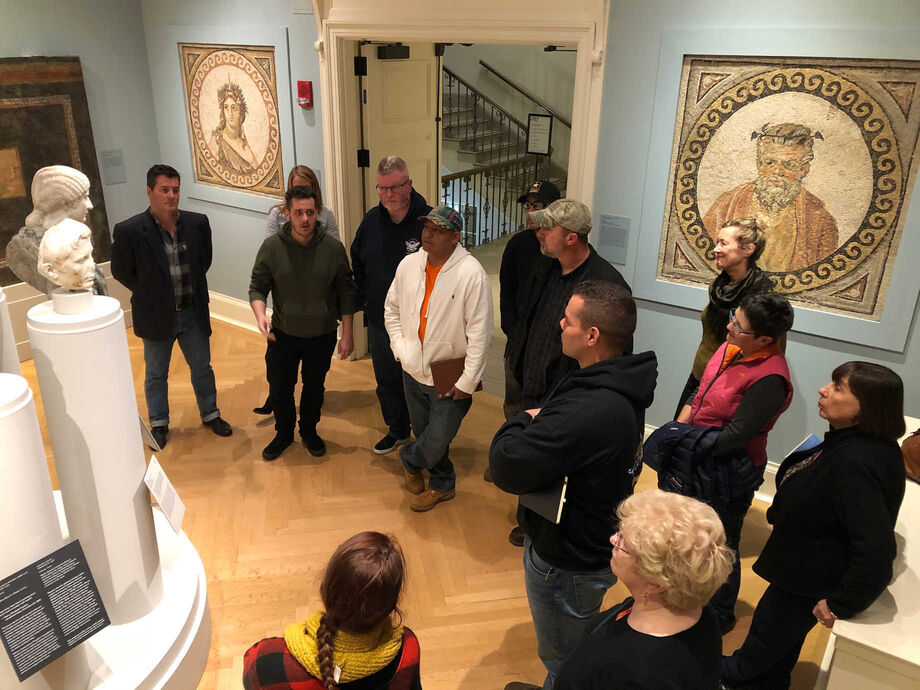 Participants in a Rhode Island Clemente Course for Veterans discuss historical representations of war at an art museum. Image courtesy of the Clemente Course.