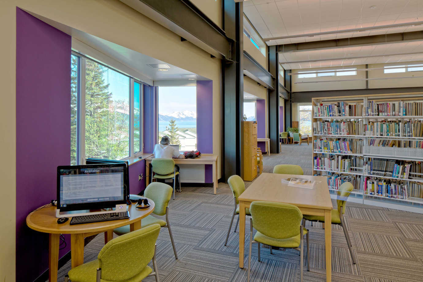 The upstairs library provides sitting and work areas with breathtaking views of the Resurrection Bay. Image courtesy of the Seward Community Library & Museum.