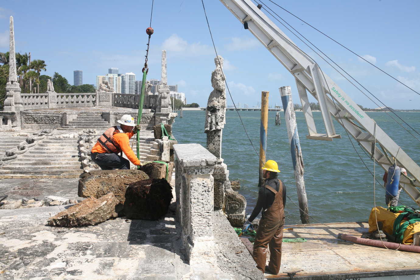 A work crew recovers elements of Vizcaya's stone barge, which were submerged and damaged during Hurricane Irma in 2017. Image courtesy of Vizcaya.