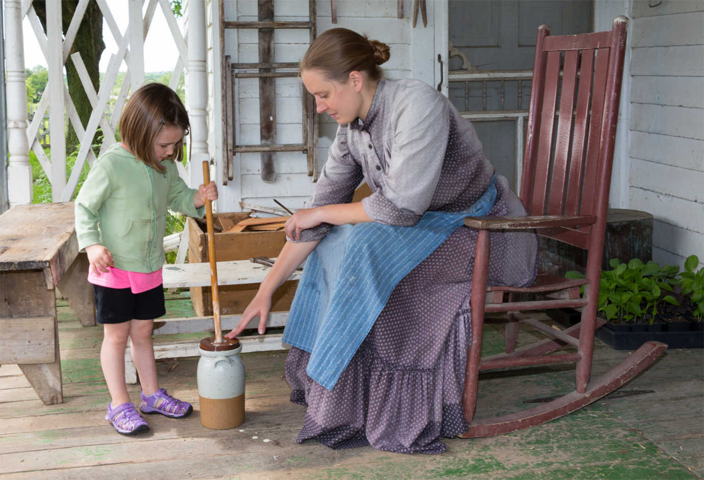 At Living History Farms, visitors can take part in traditional farm chores such as spinning wool and churning butter.  Image courtesy of Living History Farms.