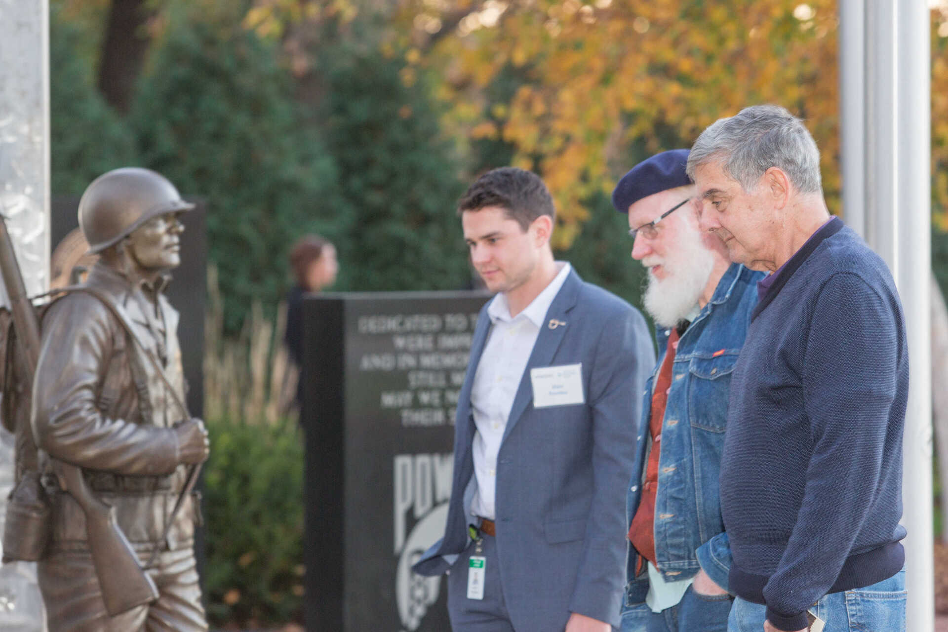 Discussion facilitators reflect upon how war is remembered in Minnesota at a war memorial in Northfield.  Photo by Michael Murray, courtesy of the Minnesota Humanities Center.