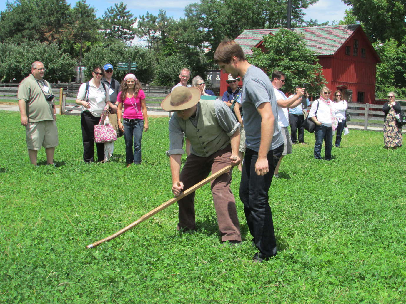 Teachers take turns using a scythe at The Henry Ford's working farm. Image courtesy of The Henry Ford.