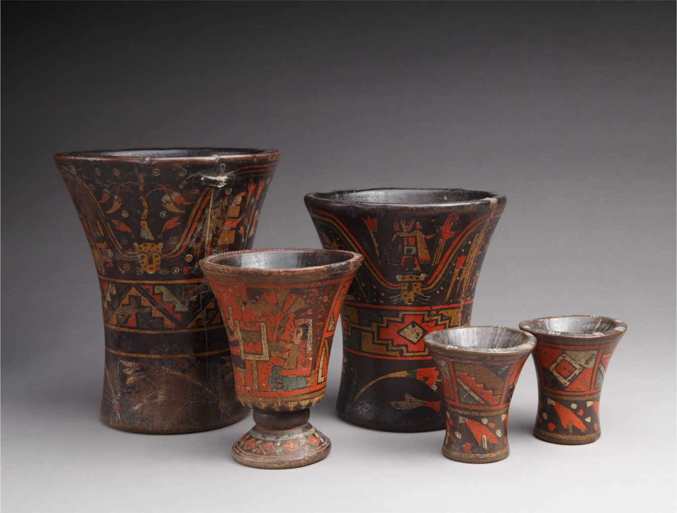 From *The Red That Colored the World*. Collection of wooden of Keros, Peru, 17th circa 18th century. Wood, paint, 8 3/8 x 6 7/8 in., 5 ½ x 4 ½ in., 3 3/8 x 3 ¼ in. Private collection. Photograph by Addison Doty. Image courtesy of the Museum of International Folk Art.