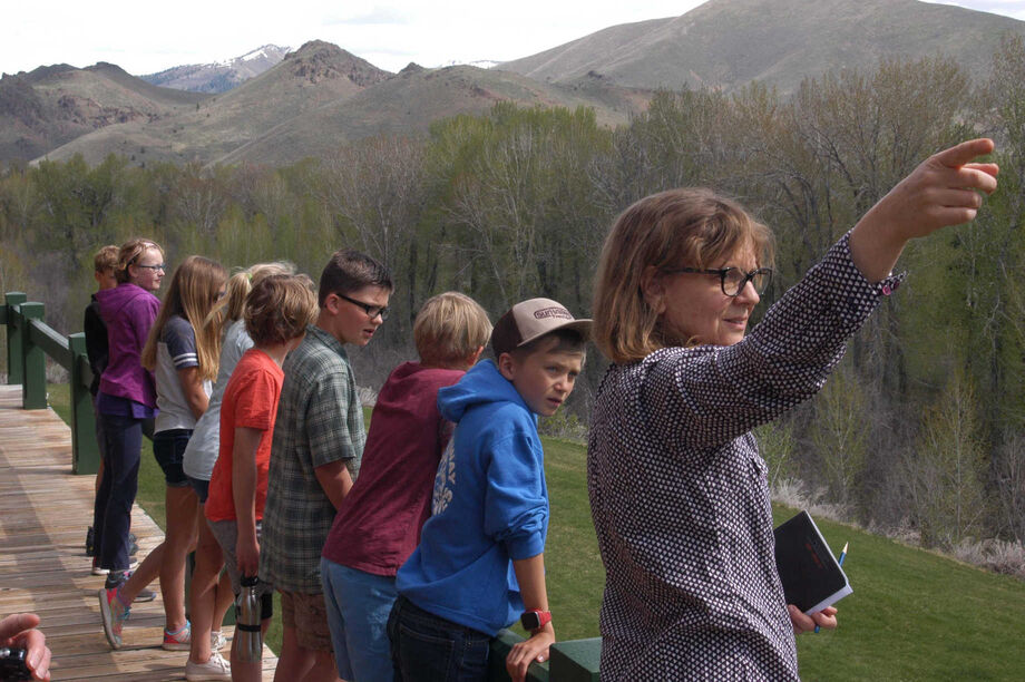 The Hemingway Legacy initiative provides opportunities for local school groups to engage with their community's historical and ecological heritage. A group of fifth graders surveys the Big Wood River landscape under the direction of Mary Tyson, the director of the Center for Regional History at the Community Library.