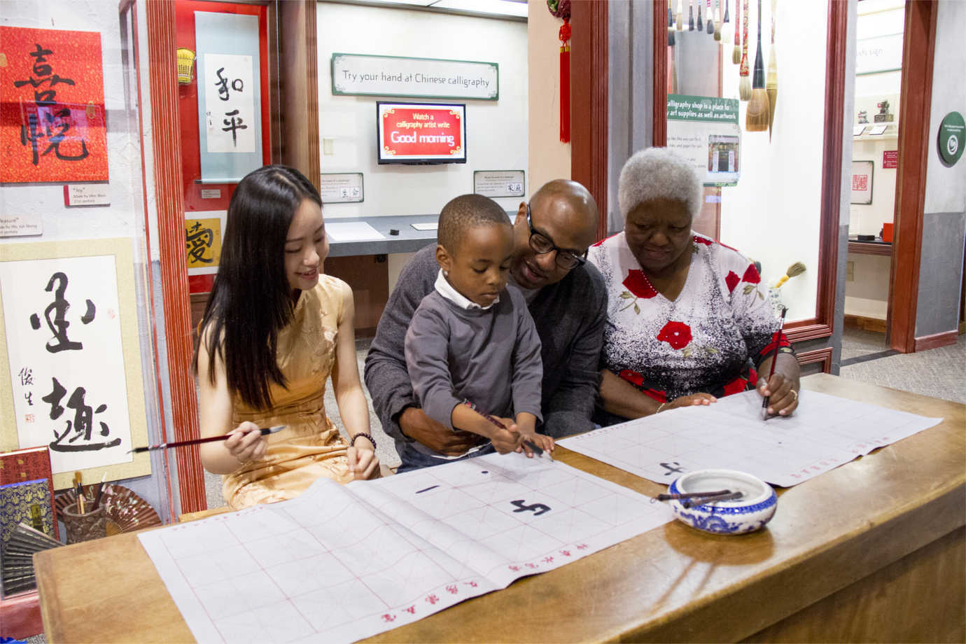 *Take Me There*, which was funded in part through an NEH grant, gives children the opportunity to explore different parts of the world through immersive experiences. In an exhibition focused on China, a child practices calligraphy. Image courtesy of the Children's Museum of Indianapolis.
