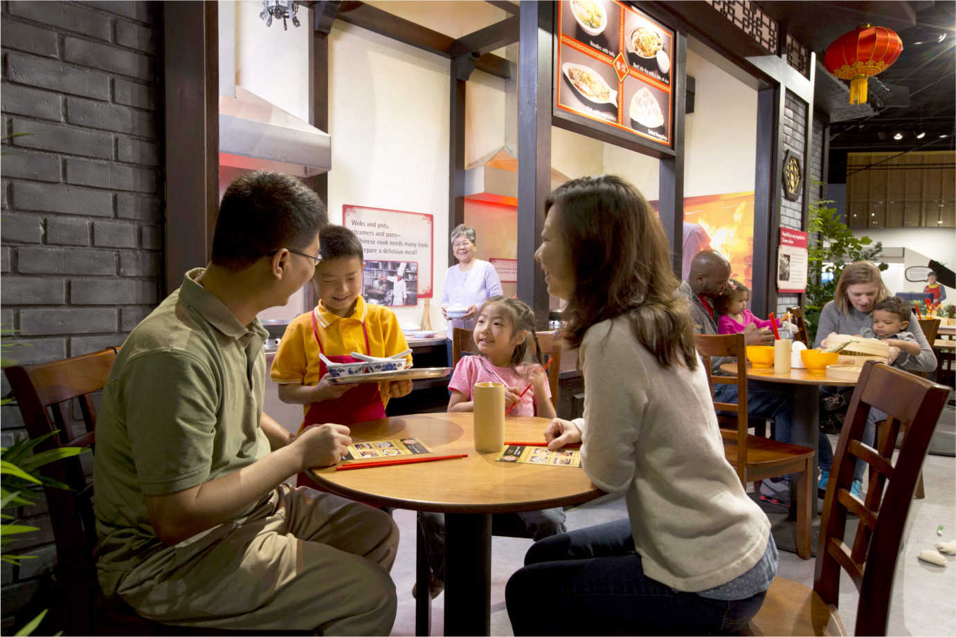 Families explore Chinese Cuisine as part of *Take Me There*. Image courtesy of the Children's Museum of Indianapolis.