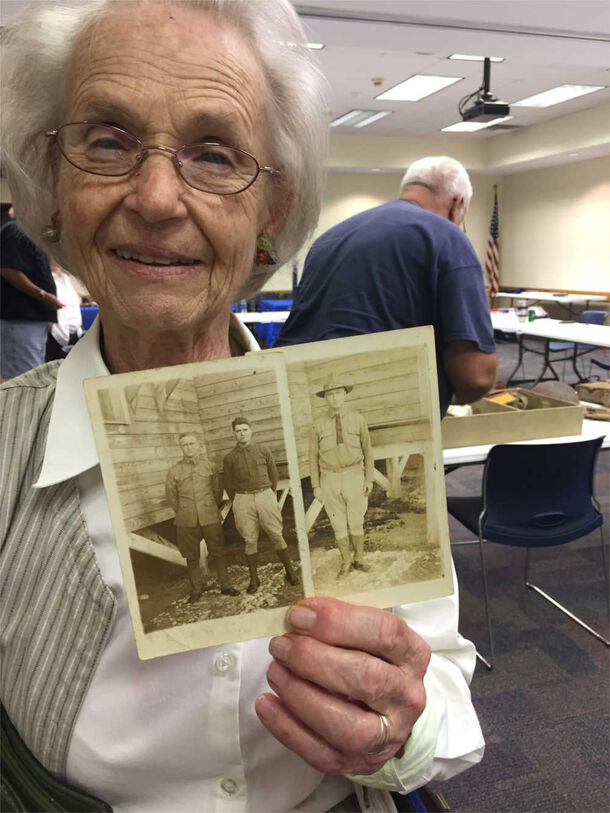 A participant in Auburn University's Dialogues on the Experience of War program shares family pictures. Dialogues on the Experience of War is an NEH-funded initiative. Image courtesy of the Caroline Marshall Draughon Center for the Arts & Humanities.
