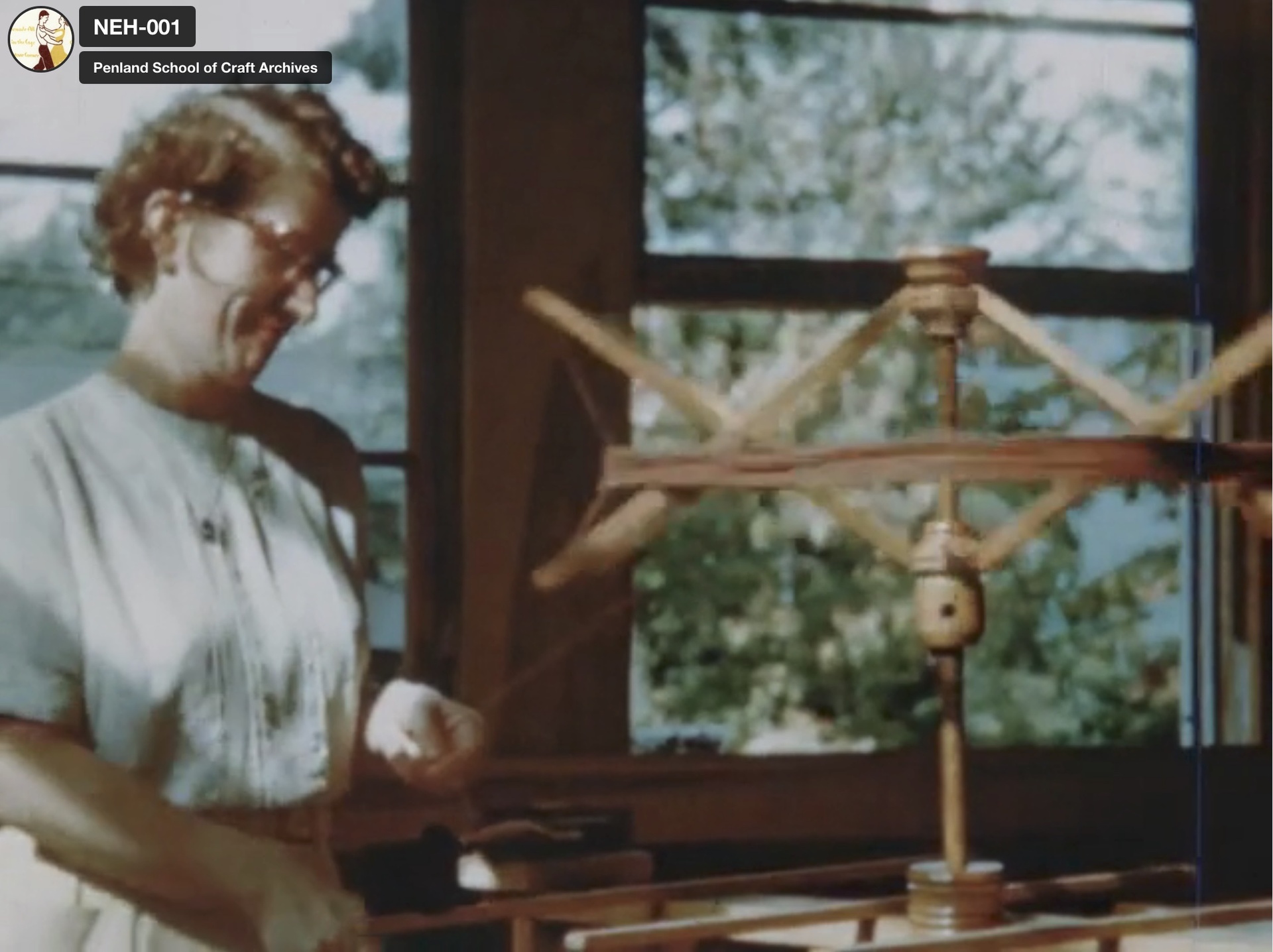 Still from 1950 film of a weaver using a yarn tree in the Penland weaving studio. Image courtesy of Penland School of Craft.