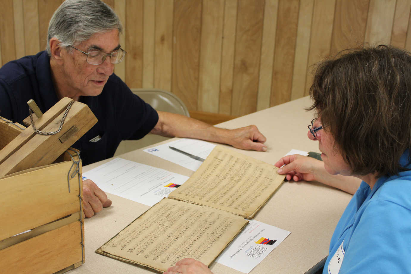 Petra DeWitt assists a participant with identifying and translating his items. Photo courtesy of Missouri Humanities.