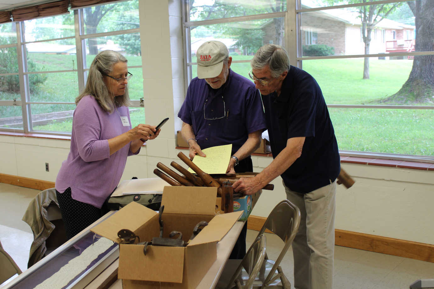 Cindy Browne of Deutschheim State Historic Site learns about Laurent Torno’s German shoemaking tools from the 1840s. Photo courtesy of Missouri Humanities.