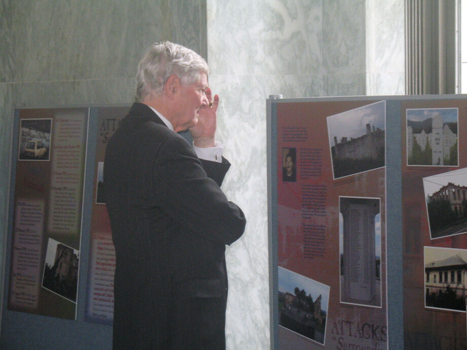 A visitor contemplates an exhibit created by the precursor to the Center for Bosnian Studies about Bosnian survivors of ethnic cleansing. Image courtesy of the Center for Bosnian Studies.
