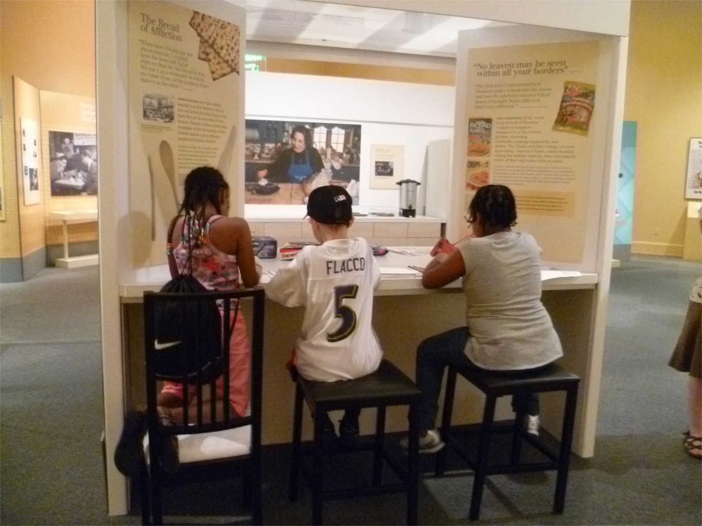 Students engage with an interactive installation, part of *Chosen Food: Cuisine, Culture, and American Jewish Identity.* Image courtesy of the Jewish Museum of Maryland.