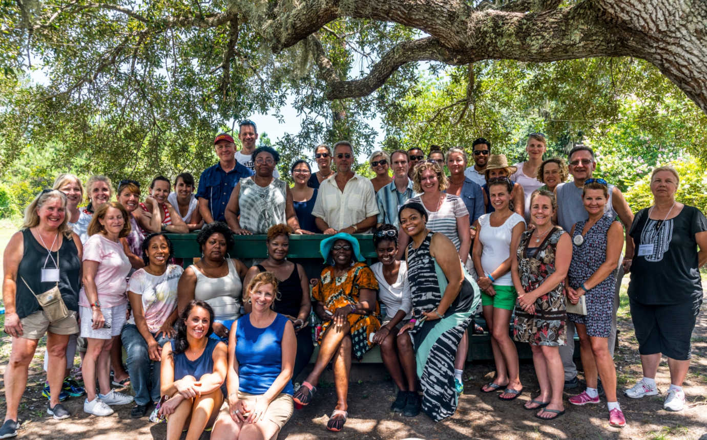 Group participants pose under a live oak with Cornelia Bailey, community advocate, cultural historian, and co-founder of the Sapelo Island Cultural and Revitalization Society. Image courtesy of Gullah Voices.