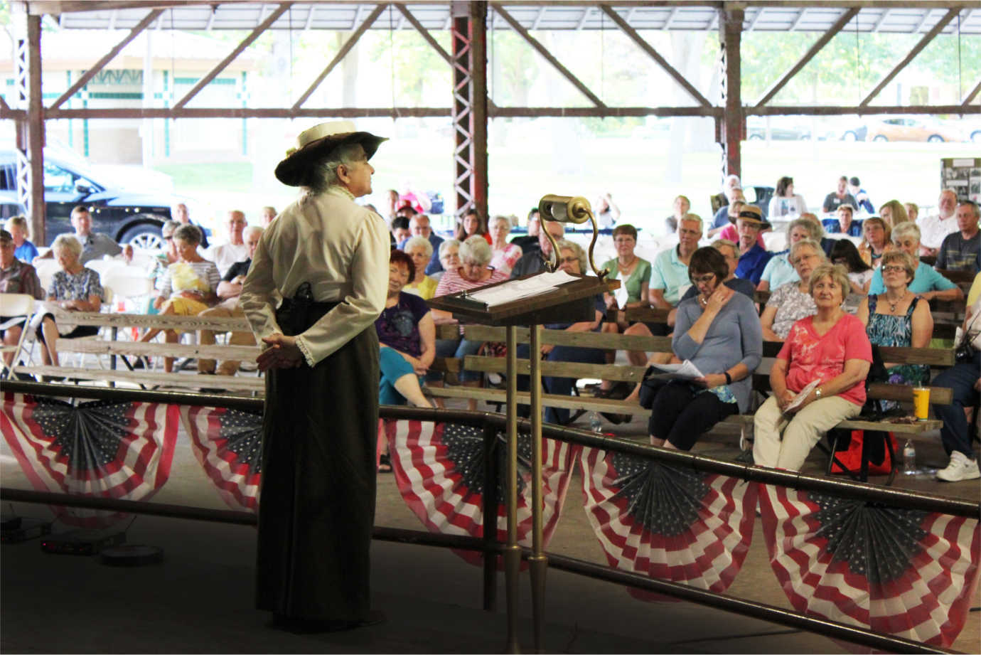 Over the course of a week, scholars-in-residence act as a catalyst for discussion around Nebraska Chautauqua's central theme. Here, a scholar dressed as Jane Addams engages an audience. Image courtesy of Humanities Nebraska.