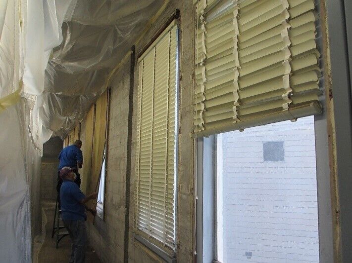 To insulate windows in their historic building and protect their collections, Bishop Museum staff first had to remove plywood that had been previously installed. Image courtesy of the Bishop Museum.