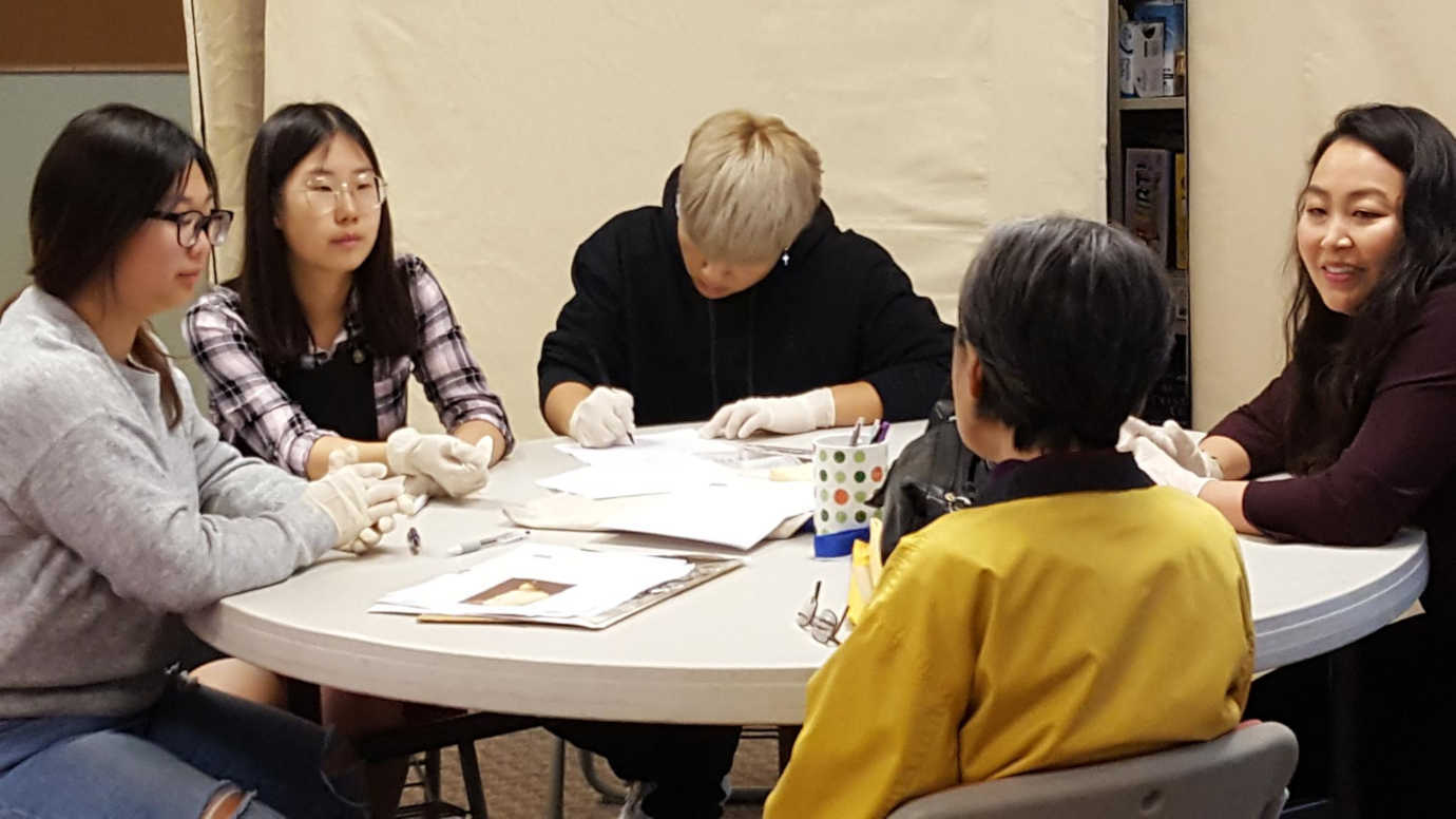 Student volunteers conduct an intake interview, capturing the story behind the item digitized. Photo courtesy of Korean American Historical Society.