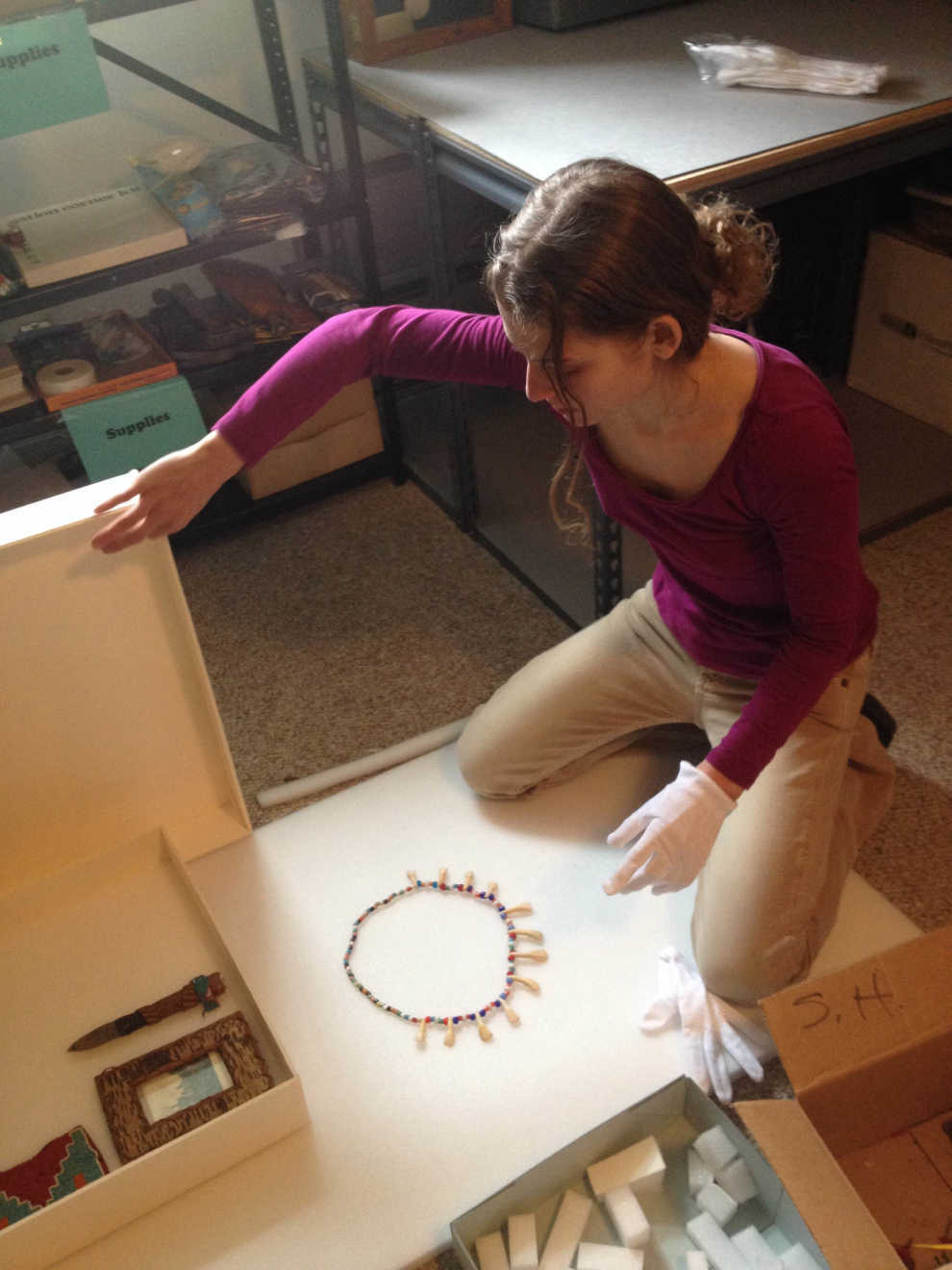 Tomaquag staff member works to inventory and rehouse items in the collections. Photo courtesy of Tomaquag Museum.