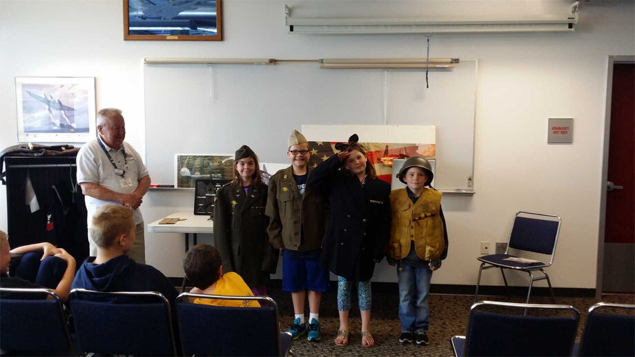 Through the Richard I. Bong Veterans Historical Center's traveling trunk program, students can hold and even try on historical objects from its archival collections. Image courtesy of the Richard I. Bong Veterans Historical Center.