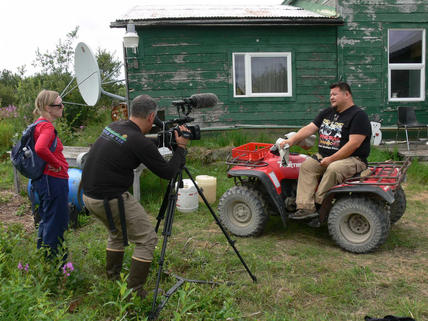Ringsmuth (left) interviews former village resident Brad Angasan (sitting on four-wheeler) while Scott Jensen, of Jensen Hall Creative, films the interview for a short documentary for the exhibition that presents the story of cannery life from the local perspective, entitled, *The Cannery Caretakers*. Image courtesy of the NN Cannery History Project.
