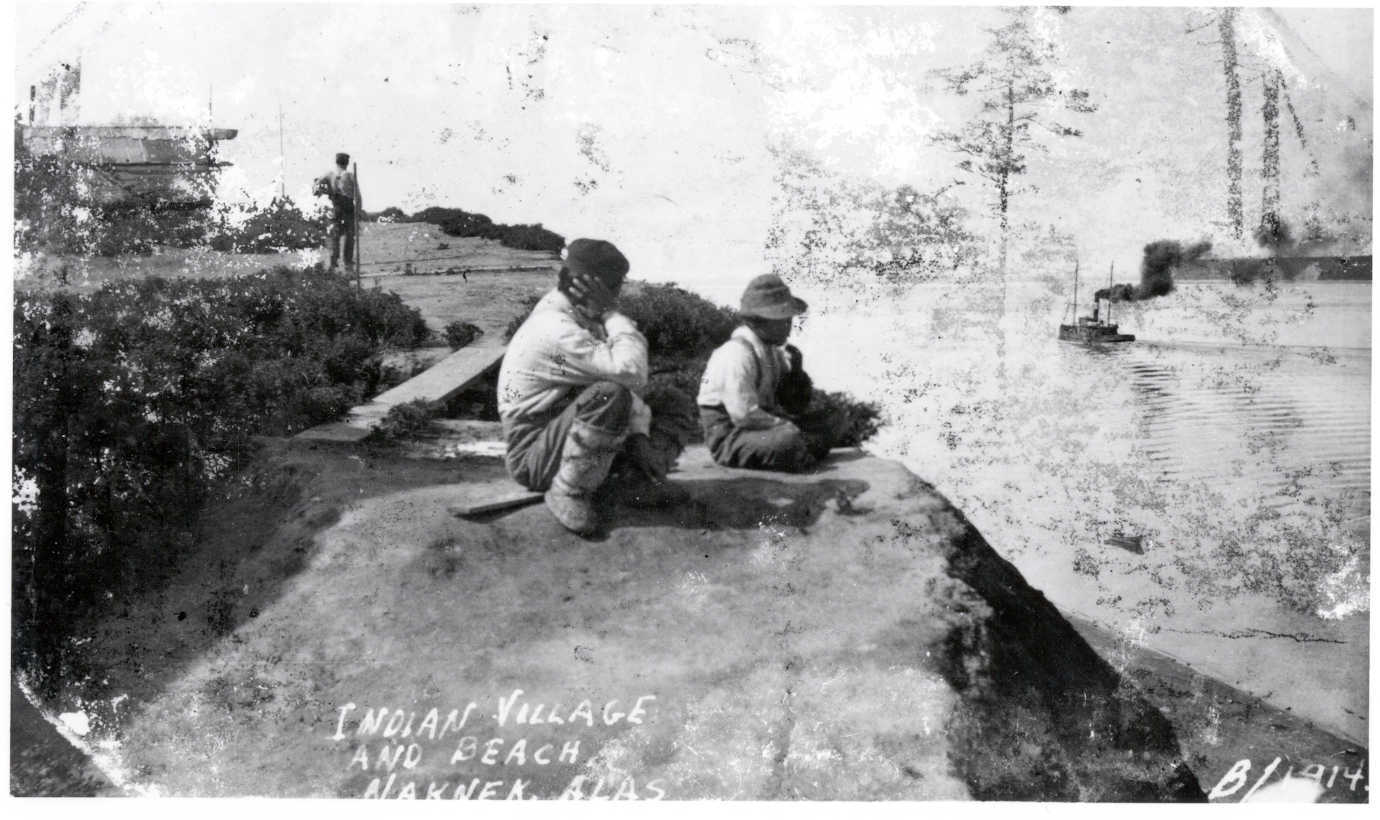 A man and boy possibly from Kiniaak Village at South Naknek watch a steamer move downriver, 1914. APA Collections, NPS San Francisco Maritime National Historic Park. Image courtesy of the NN Cannery History Project.