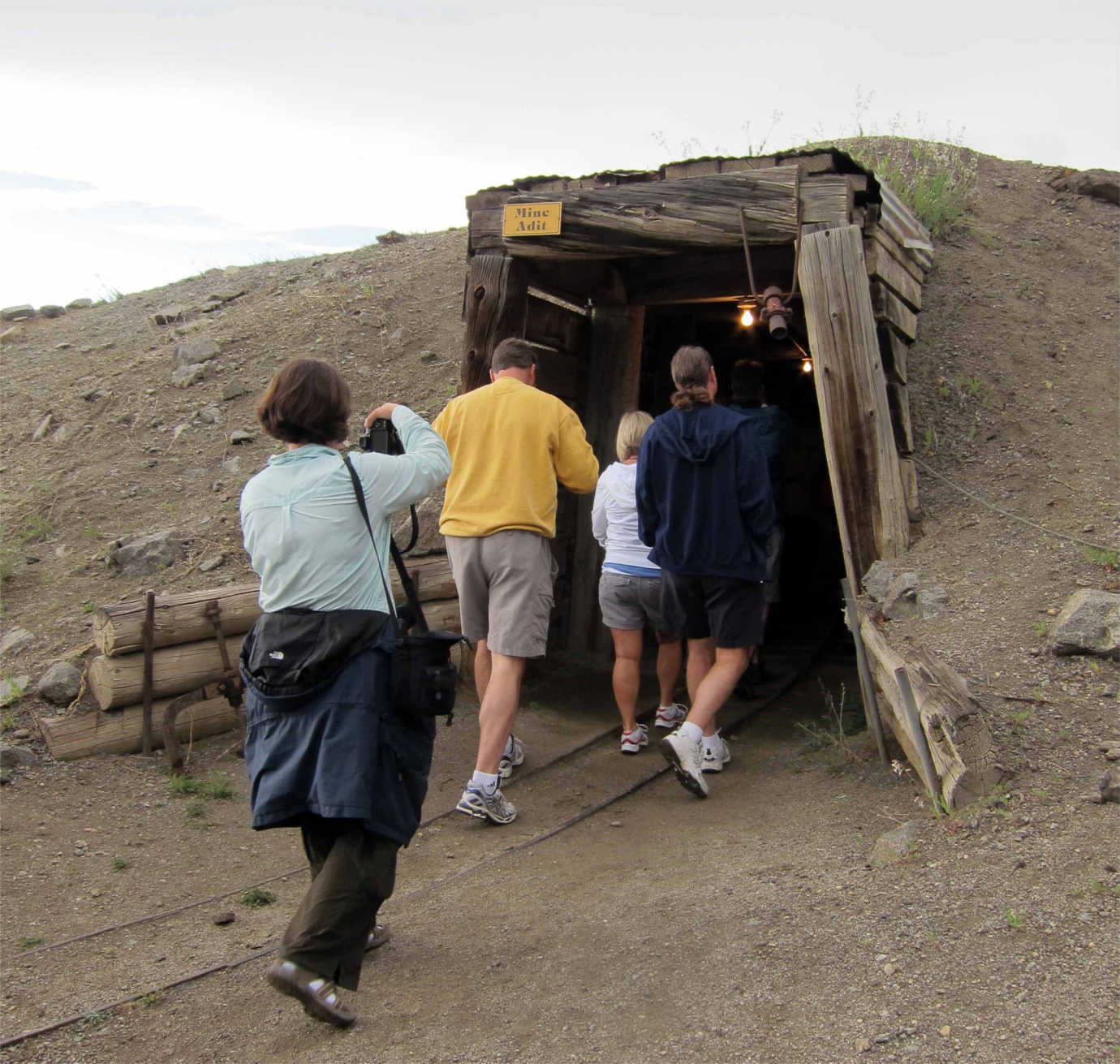 Teachers participating in a tour enter a mine. Image courtesy of the Montana Historical Society.