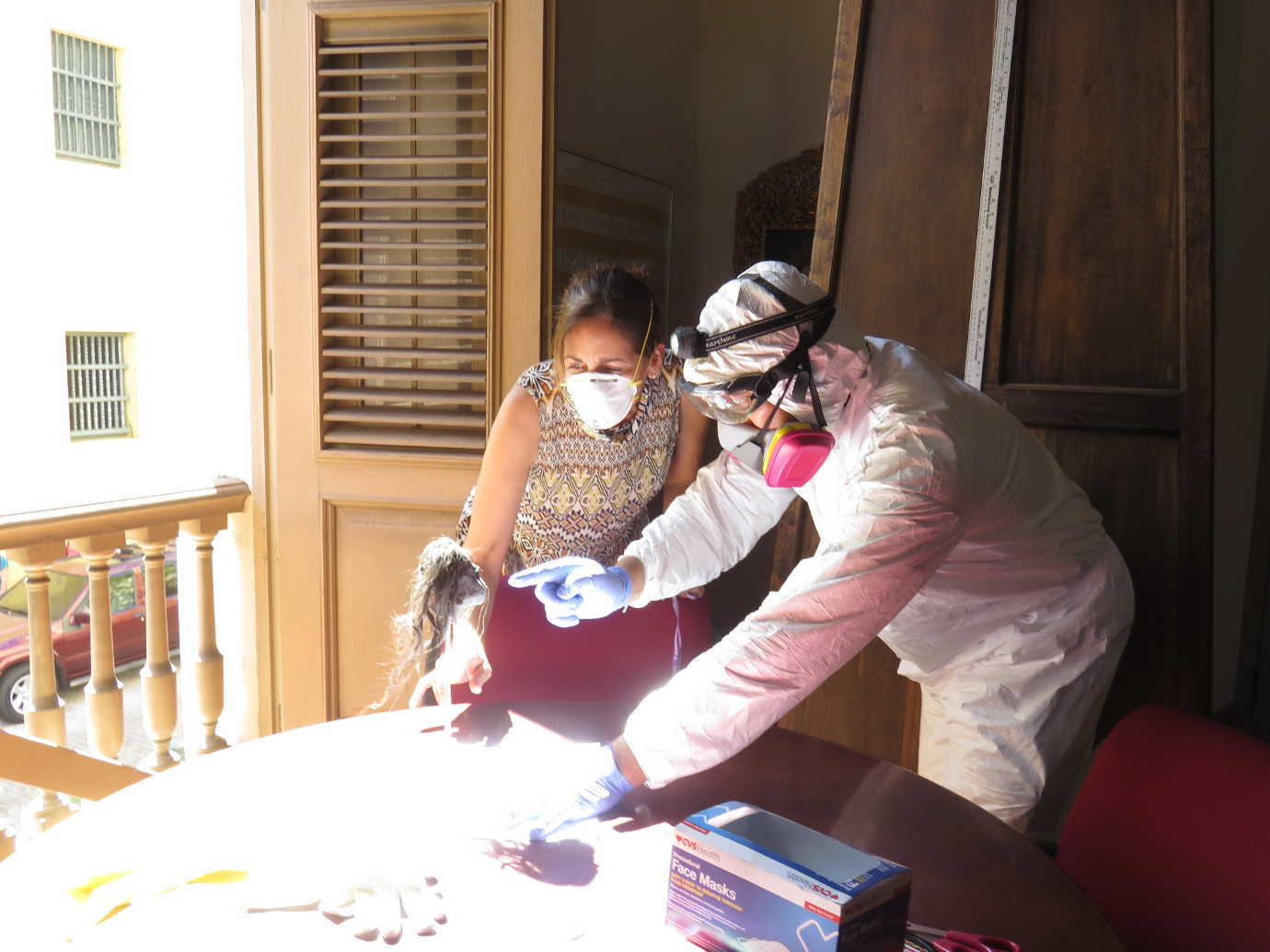 National Heritage Responder Molly O’Guinness Carlson instructs a staff member on how to effectively dry an object in the sunlight at a Puerto Rican museum. Image courtesy of FAIC.