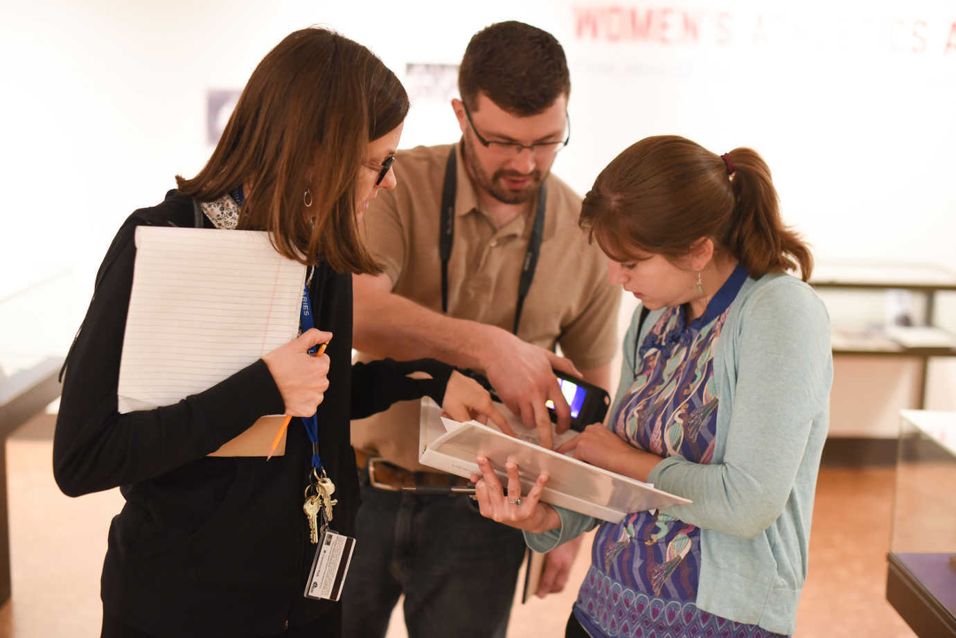 Whitney Baker (left, University of Kansas Libraries) confers with IPI consultants, Christopher Cameron and Kelly McCauley Krish. Image courtesy of University of Kansas Libraries.