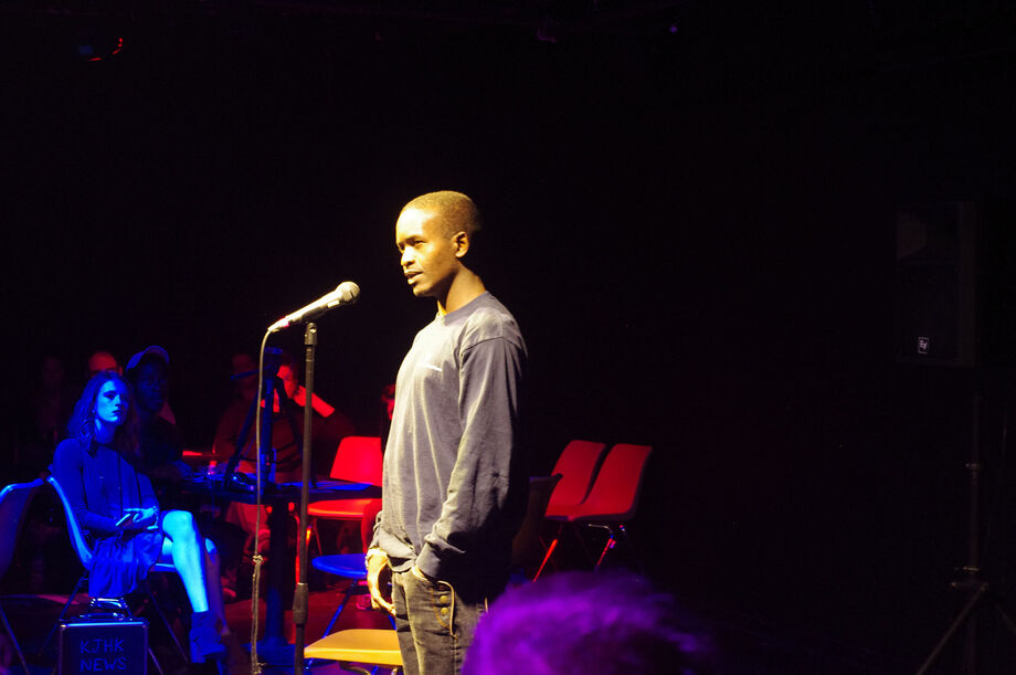 A participant in the project's Storylab workshop shares his migration story publicly at a local Story Slam. Image courtesy of the Kansas African Studies Center at the University of Kansas.