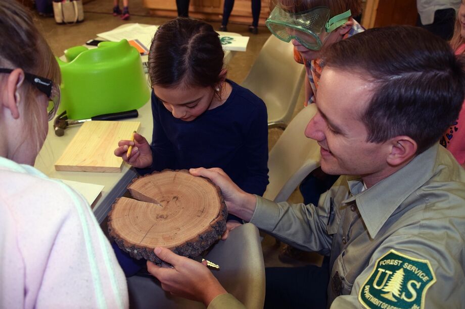 As part of “Our Heritage of Wood and Crafting,” a representative from the U.S. Forest Service helped 4-H youth learn about how people have used the local forests throughout history. Photo courtesy of Entrada Institute, Inc