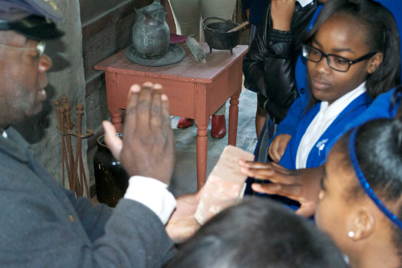Participants examine historic artifacts in former slave quarters as part of their tour “Behind the Big House,” funded through the Racial Equity Grants program. Photo courtesy of Mississippi Humanities Council.