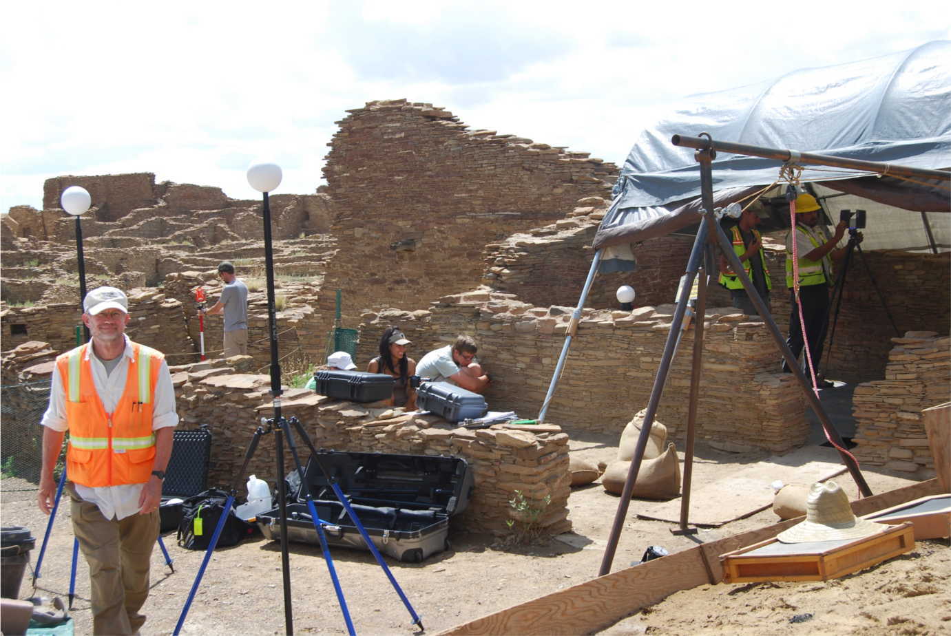 Students crouch behind wall to avoid being mapped into LiDAR.  Photograph by Patricia Crown.